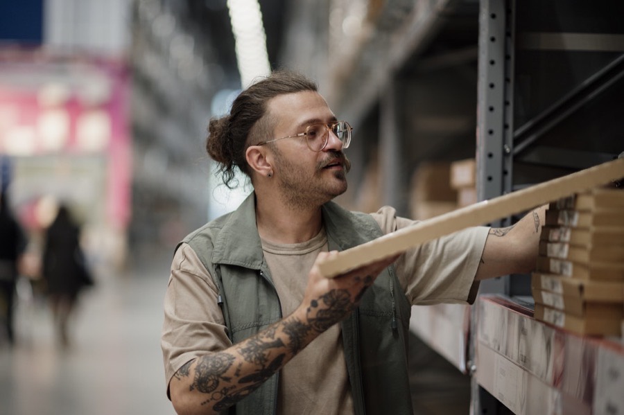 A customer selecting timber from the racks inside a hardware store